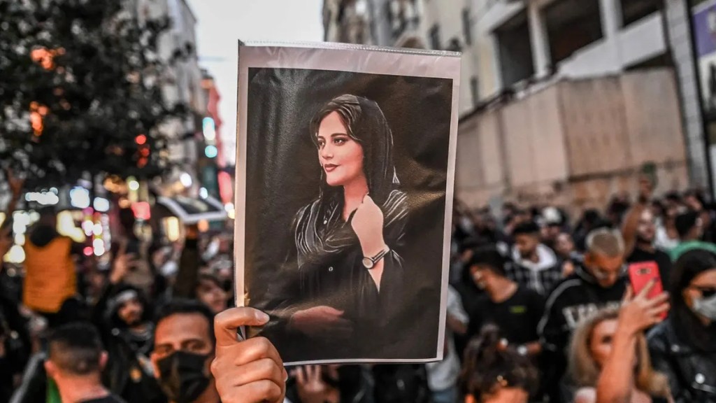 Protestor carries photograph of Mahsa Amini