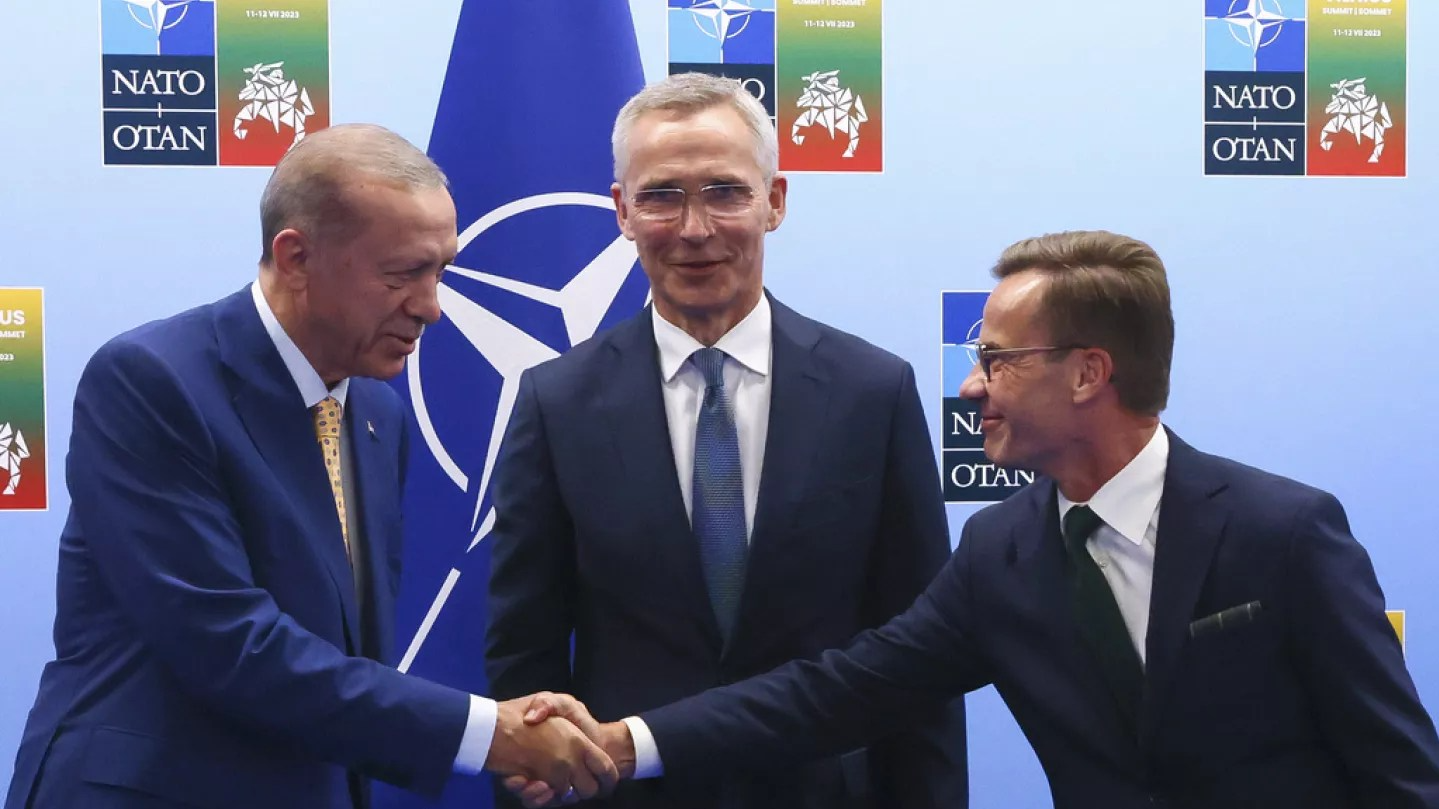 Turkish President Recep Erdogan and Swedish Prime Minister Ulf Kristersson shake hands at NATO Summit