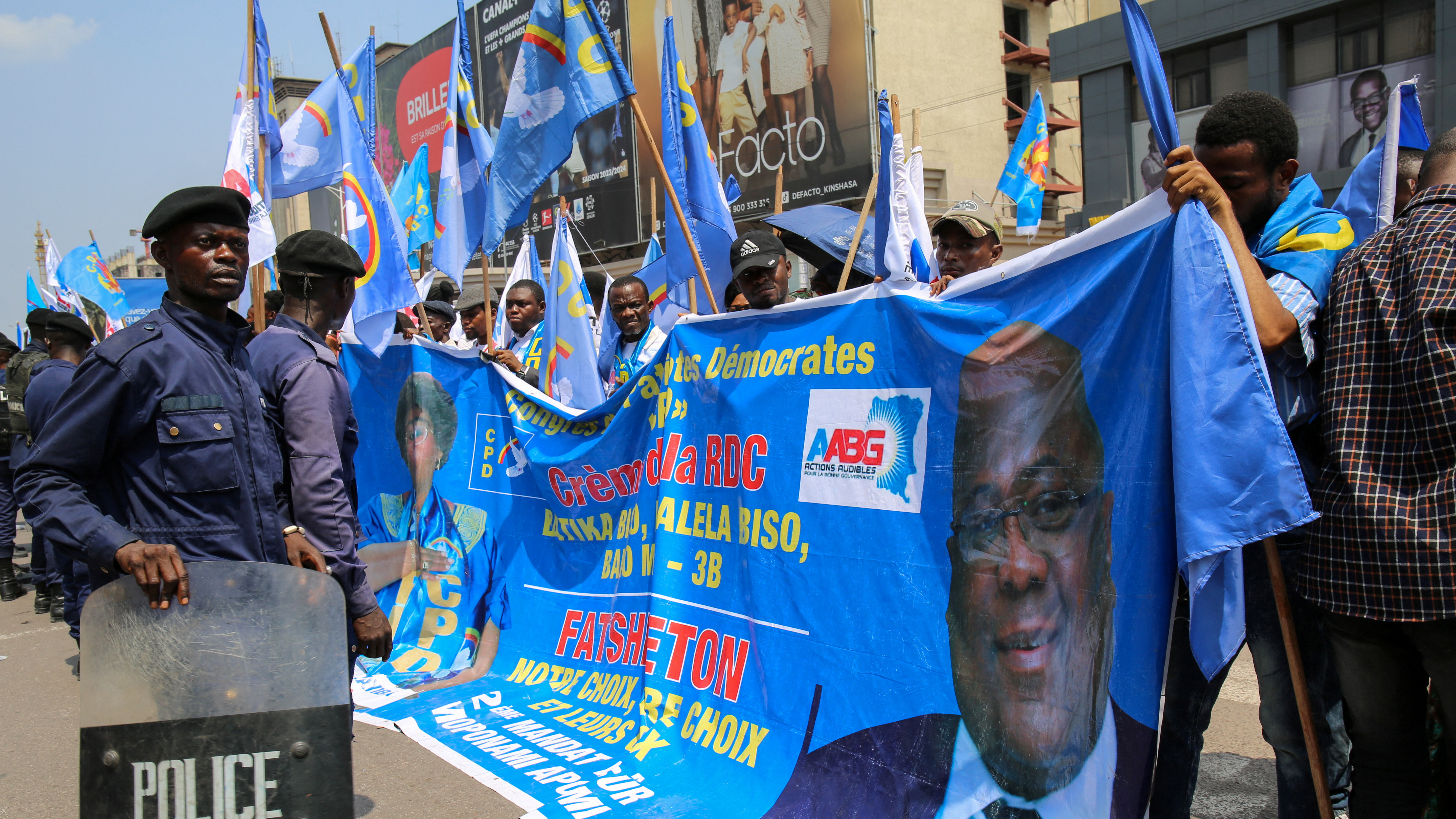 Police officers monitor the crowd at a political rally in Kinshasa in October